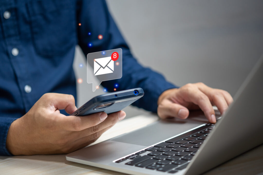 businessman holding hand touchscreen smartphone and checking email icon online or sending mail to partner and customer on web with virtual interface technology concept